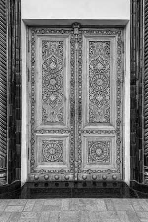 Carved antique wooden doors with patterns and mosaics. black and white.の写真素材