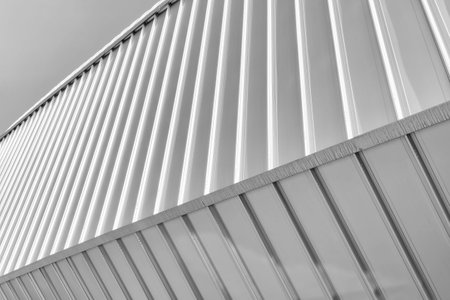 Black and white fragment of a modern building covered with metal aluminum panels.の写真素材