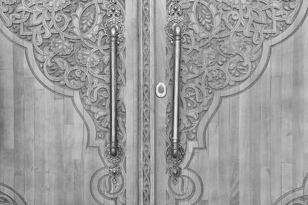Black and white Carved antique wooden doors with patterns and mosaics.の写真素材