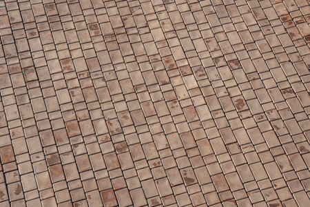 The texture of a red tiled pavement with perspective. Abstract background for design.