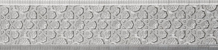 Geometric traditional Islamic ornament. Fragment of a carved mosaic on white marble. abstract...