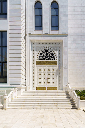 White carved antique wooden doors with patterns, golden metal jewelry and mosaics. abstract background.の写真素材