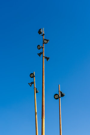 Pillars with modern LED lanterns against the blue sky background.の写真素材