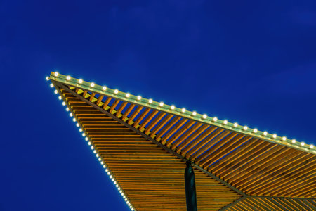 Holiday garlands with lamps against the blue night sky. Xmas decorations.