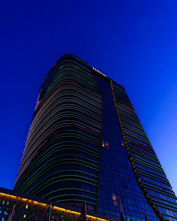 Uzbekistan, Tashkent - September 27, 2023: Hilton hotel building in night illumination on a blue sky background.のeditorial素材