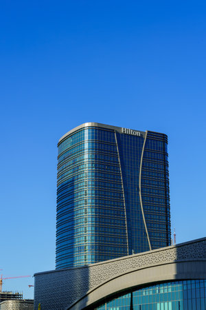 Uzbekistan, Tashkent - September 27, 2023: Building of hotel Hilton on a blue sky background in Tashkent city district.のeditorial素材
