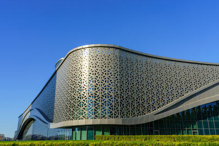 Uzbekistan, Tashkent - September 27, 2023: Building of hotel Hilton on a blue sky background in Tashkent city district.のeditorial素材