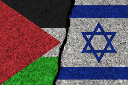 The crack between the Palestine and Israel flags on the concrete wall. The concept of sanctions, war, the deterioration of diplomatic relations, confrontation and severance of agreements.の写真素材