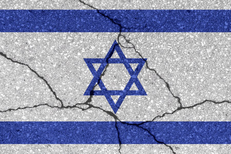 Israel flag on cracked concrete wall. The concept of crisis, default, economic collapse, pandemic, conflict, terrorism, war or other problems in the country. Abstract disaster symbol.の写真素材