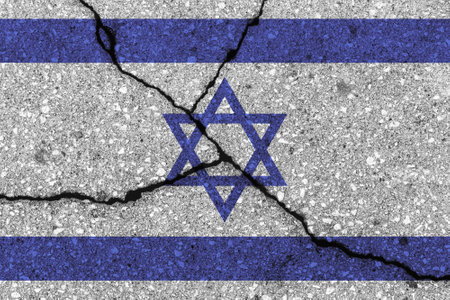 Israel flag on cracked concrete wall. The concept of crisis, default, economic collapse, pandemic, conflict, terrorism, war or other problems in the country. Abstract disaster symbol.の写真素材