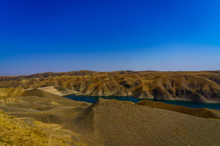 A deserted part of the Zaamin nature reserve in Uzbukistan on a sunny summer day. View of the mountains and reservoir from above.の写真素材