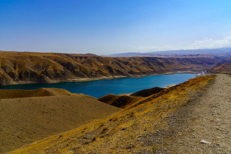 A deserted part of the Zaamin nature reserve in Uzbukistan on a sunny summer day. View of the mountains and reservoir from above.の写真素材