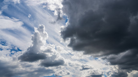 White dramatic cumulus clouds in the blue sky. Cloudy sky nature background. Overcast weather.