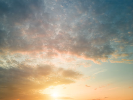 The rays of the sun breaking through the dramatic clouds in the evening or in the morning in the sunset or dawn sky. The concept of faith, hope for the best or good weather.の写真素材