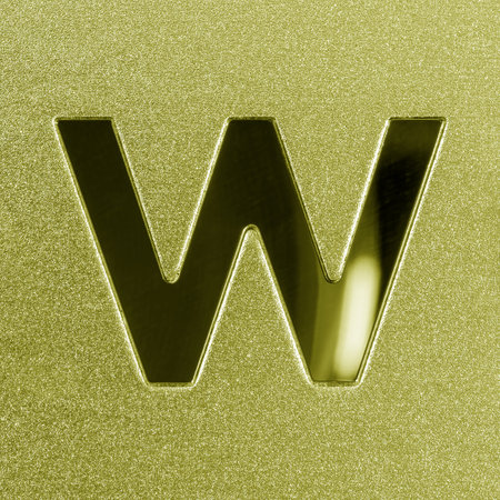 Letter W on a golden grained shiny metal surface. English alphabet. Element for design.の写真素材