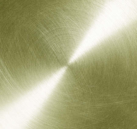 Golden circular brushed shiny metal texture. Abstract metallic background for design. Circle shape.の写真素材