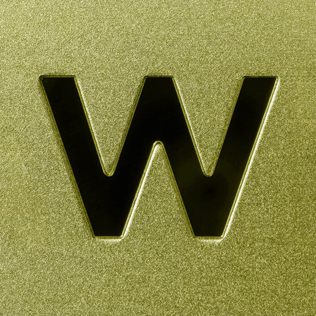 Letter W on a golden grained shiny metal surface. English alphabet. Element for design.の写真素材