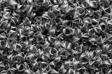 Background of steel wires twisted into spirals in the form of prisms. Spiral-prismatic nozzle. Abstract metal background for design.の写真素材