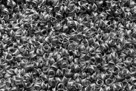 Background of steel wires twisted into spirals in the form of prisms. Spiral-prismatic nozzle. Abstract metal background for design.の写真素材