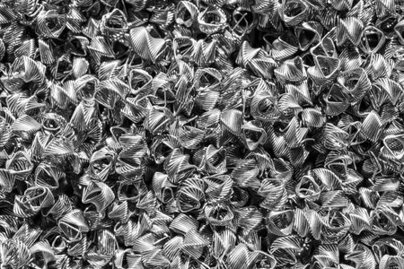 Background of steel wires twisted into spirals in the form of prisms. Spiral-prismatic nozzle. Abstract metal background for design.の写真素材