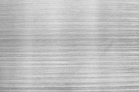 Monochrome texture of shiny scratched metal. Abstract background for design.の写真素材