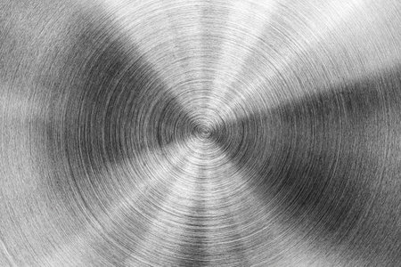 Stainless steel or aluminum circular brushed shiny metal texture. Abstract metallic background for design. Circle shape.の写真素材