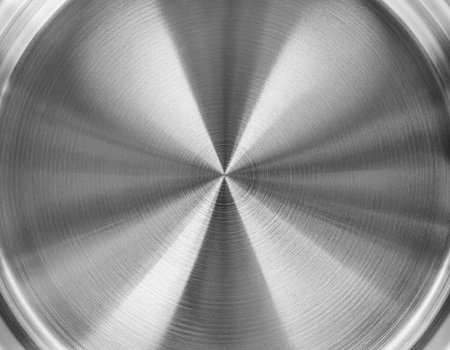 Stainless steel or aluminum circular brushed shiny metal texture. Abstract metallic background for design. Circle shape.の写真素材