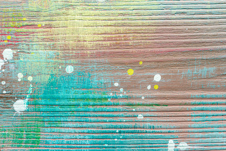 Colorful painted textured wooden plank with a paint stains. Abstract background for design.の写真素材