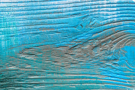 Blue painted textured wooden plank with colorful paint stains. Abstract background for design.の写真素材