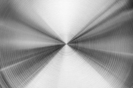 Stainless steel or aluminum circular brushed shiny metal texture. Abstract metallic background for design. Circle shape.の写真素材