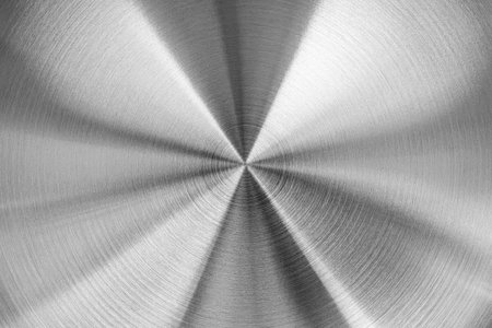 Stainless steel or aluminum circular brushed shiny metal texture. Abstract metallic background for design. Circle shape.の写真素材