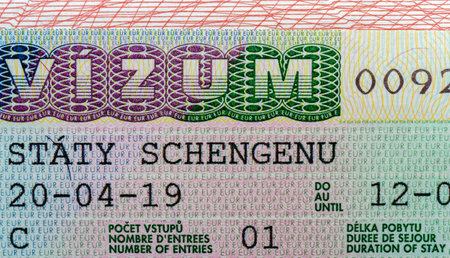 Detailed Schengen visa close-up showing security patterns, text, and design elements on a colorful background, concept of travel documents.の写真素材
