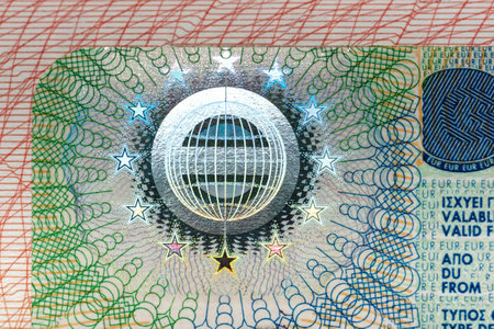 Detailed Schengen visa close-up showing security patterns, text, and design elements on a colorful background, concept of travel documents.の写真素材