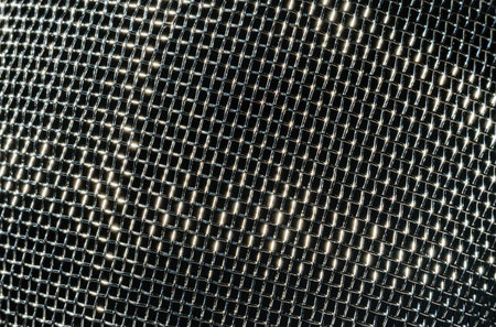 Monochrome texture of a shiny metal colander or grate. Abstract background for design.の写真素材