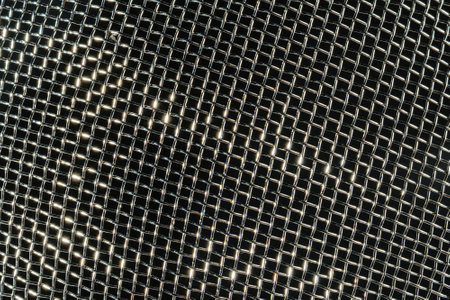 Monochrome texture of a shiny metal colander or grate. Abstract background for design.の写真素材