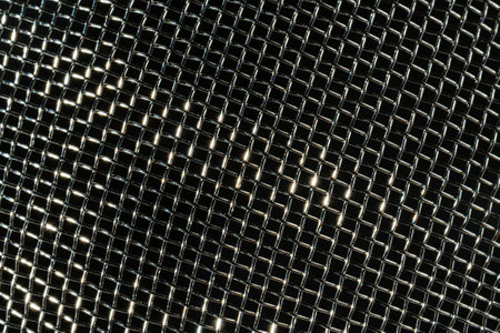 Monochrome texture of a shiny metal colander or grate. Abstract background for design.の写真素材
