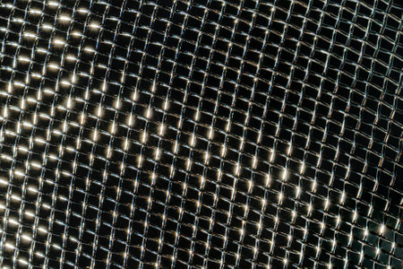 Monochrome texture of a shiny metal colander or grate. Abstract background for design.の写真素材