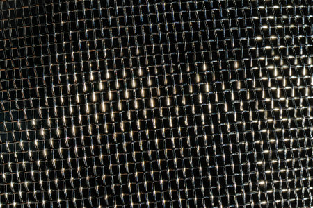 Monochrome texture of a shiny metal colander or grate. Abstract background for design.の写真素材