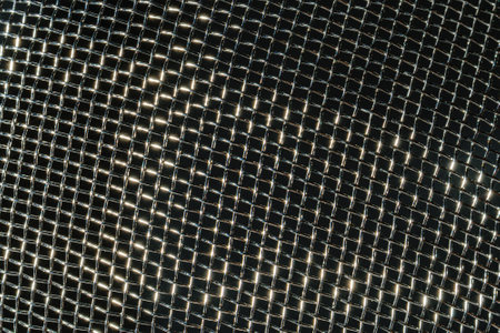 Monochrome texture of a shiny metal colander or grate. Abstract background for design.の写真素材