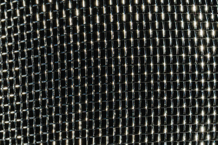 Monochrome texture of a shiny metal colander or grate. Abstract background for design.の写真素材