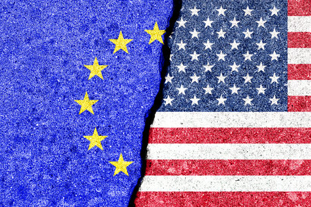 The crack between the flags of the United States and the European Union. The concept of problems in the relations of countries, trade tariffs and disagreements.の写真素材