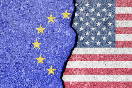 The crack between the flags of the United States and the European Union. The concept of problems in the relations of countries, trade tariffs and disagreements.の写真素材