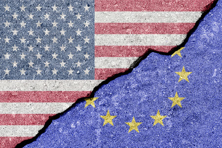 The crack between the flags of the United States and the European Union. The concept of problems in the relations of countries, trade tariffs and disagreements.の写真素材