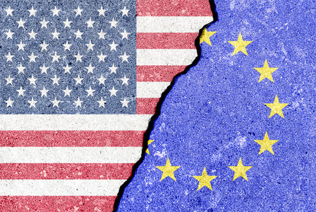 The crack between the flags of the United States and the European Union. The concept of problems in the relations of countries, trade tariffs and disagreements.の写真素材