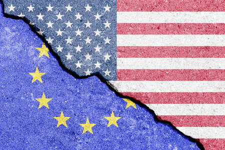 The crack between the flags of the United States and the European Union. The concept of problems in the relations of countries, trade tariffs and disagreements.の写真素材