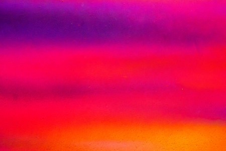 A fragment of colorful paint on a wall. Abstract urban background for design. Spray painting art.の写真素材