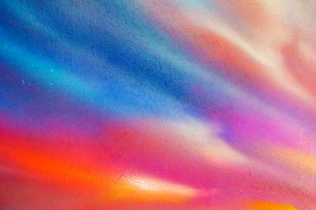 A fragment of colorful graffiti painted on a wall. Abstract urban background for design. Spray painting art.の写真素材