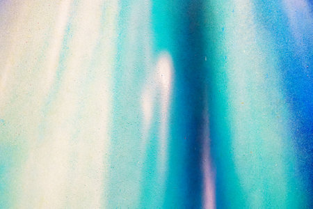 A fragment of colorful graffiti painted on a wall. Abstract urban background for design. Spray painting art.の写真素材
