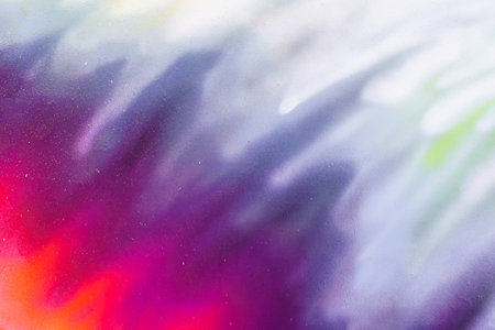 A fragment of colorful graffiti painted on a wall. Abstract urban background for design. Spray painting art.の写真素材