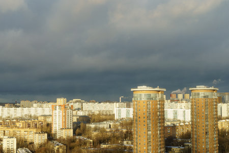 Urban residential complex with vibrant facades in a cityscape, sunny weather, and cloudy sky, concept of modern city architecture.の写真素材